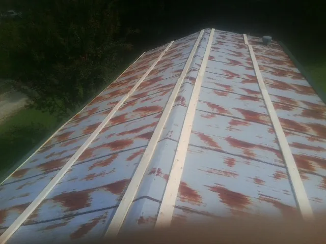 Rusted metal roof panels with new wood purlins before replacement — Storm Damage Roof Repair in Brookston by Roofing Brothers